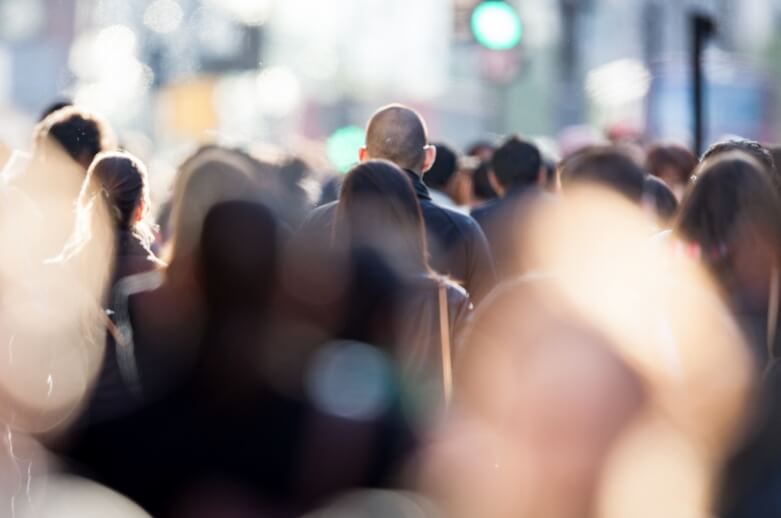 A crowd of people in a busy city