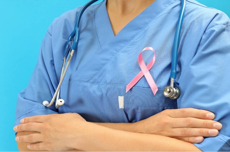 A female nurse in uniform crossing arms
