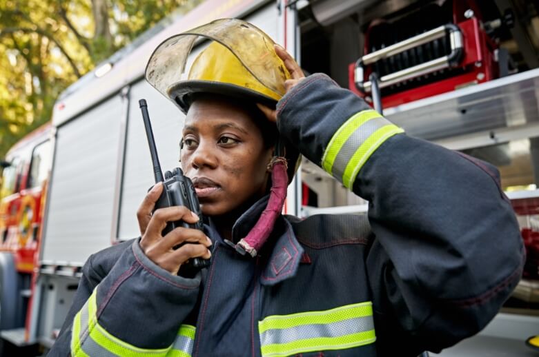A firefighter speaking on a radio