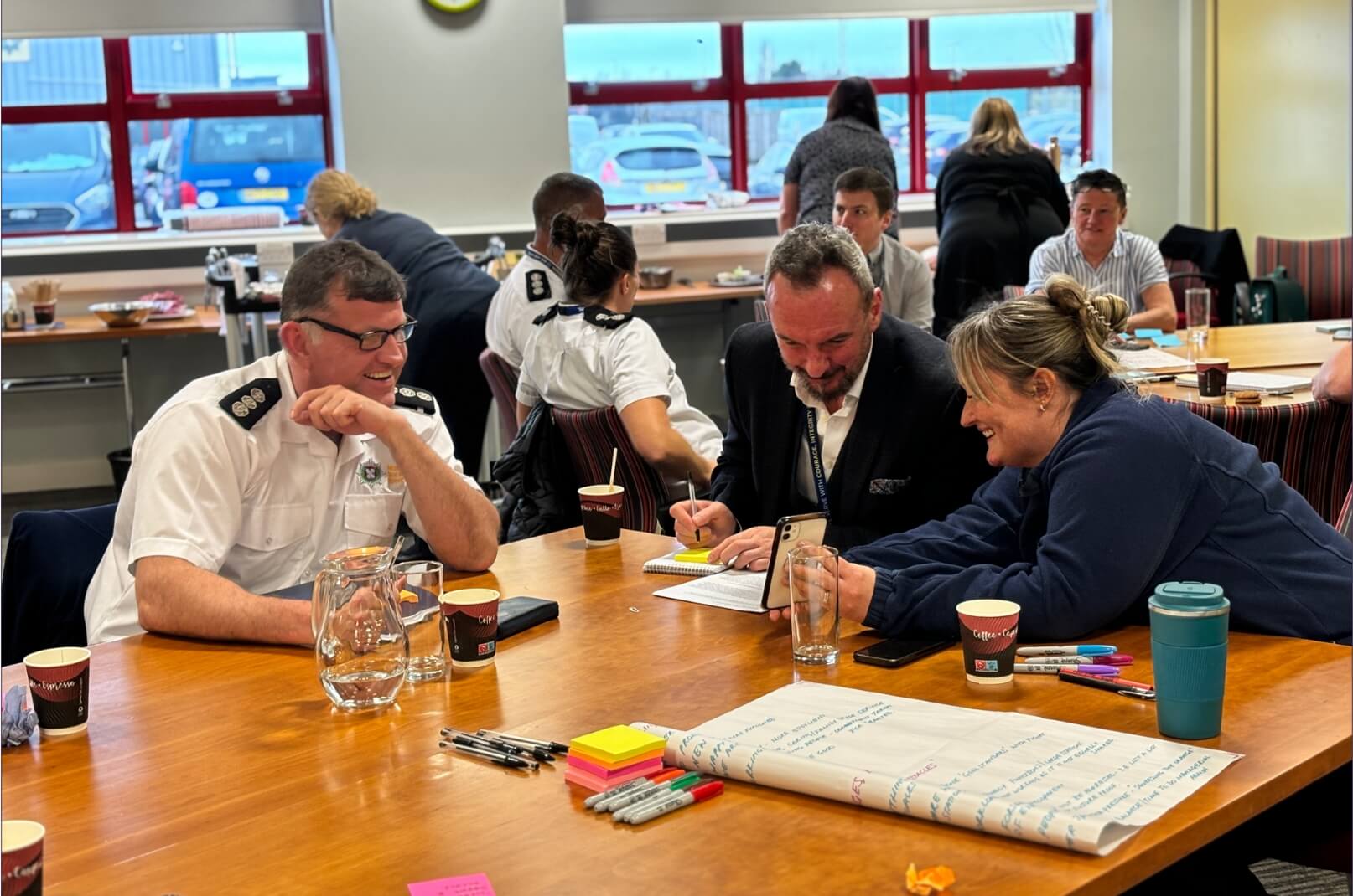 A group of people around a table with coffee