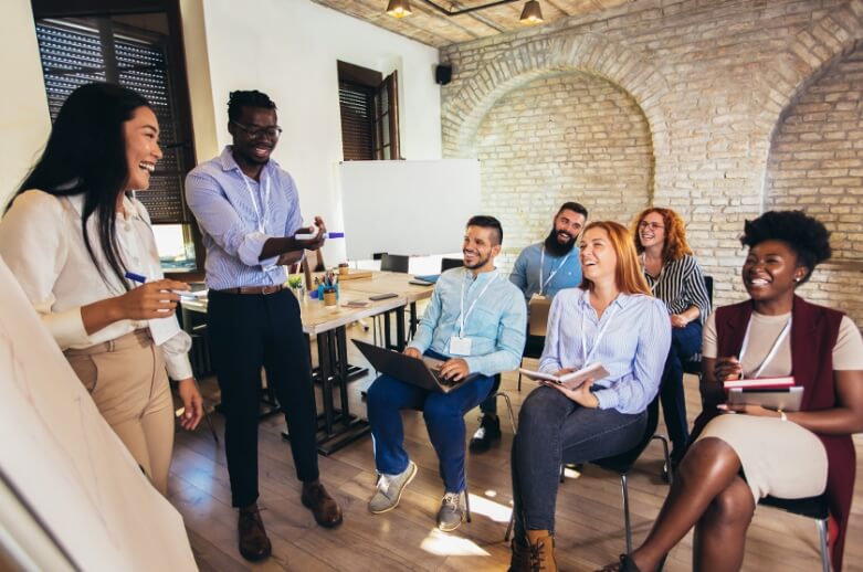 A group of people having a meeting with lots of laughs