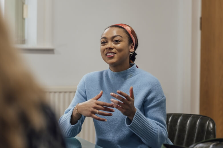 A woman sharing a story to a group of people