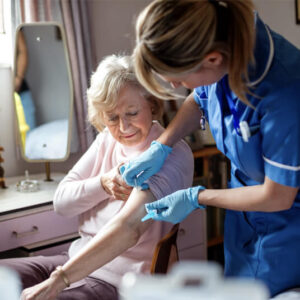 An elderly woman receiving a vaccination