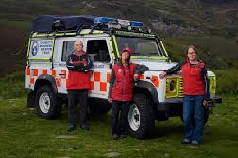 Mountain Rescue proudly standing next to rescue truck
