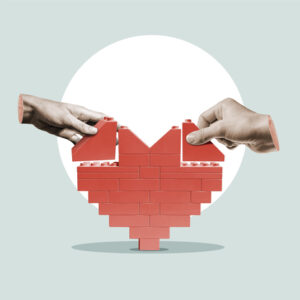 2 hands holding a lego heart